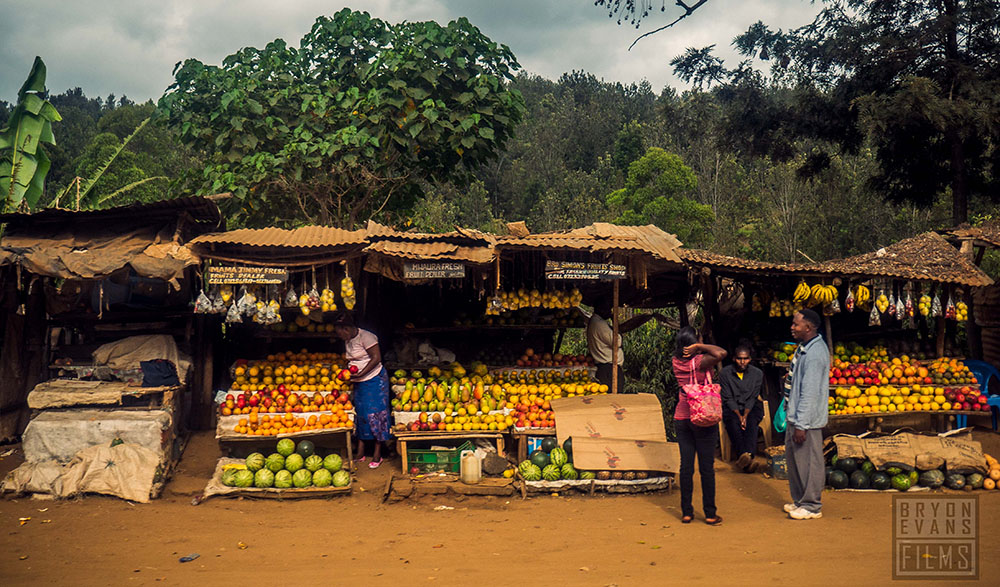 People shopping at a Kenyan fruit market